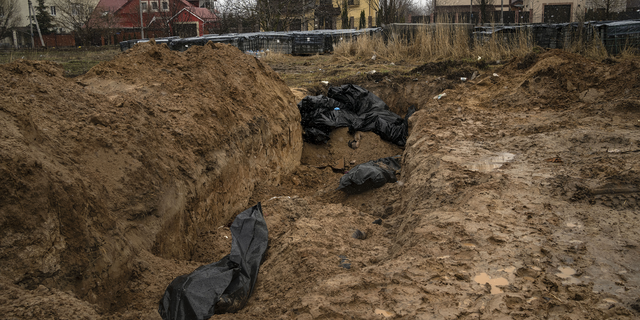 Bodies lie in a mass grave in Bucha, on the outskirts of Kyiv, Ukraine, on Sunday.