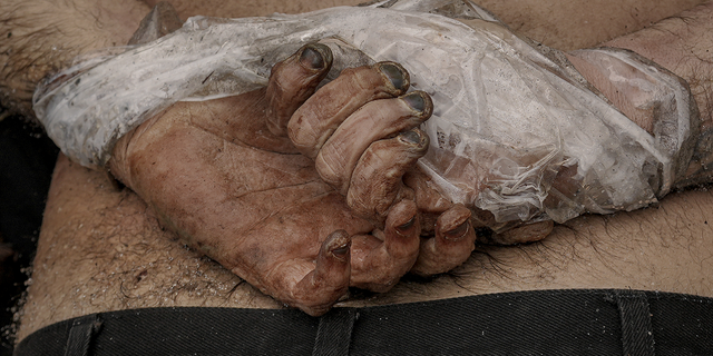 WARNING: GRAPHIC IMAGE: A lifeless body of a man with his hands tied behind his back lies on the ground in Bucha, Ukraine, on Sunday.