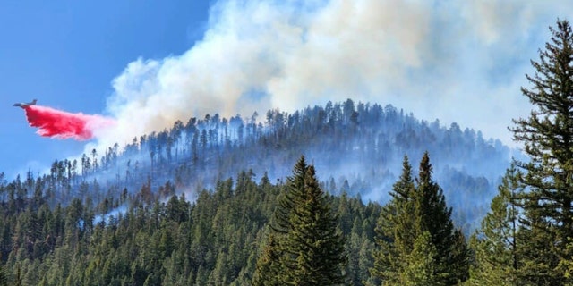 An air tanker utilizes retardant to slow the progression of the Calf Canyon and Hermits Peak Fires