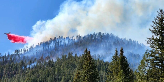 An air tanker utilizes retardant to slow the progression of the Calf Canyon and Hermits Peak Fires