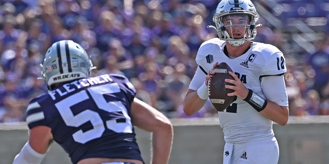 Quarterback Carson Strong #12 of the Nevada Wolf Pack drops back against linebacker Cody Fletcher #55 of the Kansas State Wildcats, during the second half at Bill Snyder Family Football Stadium on Sept. 18, 2021 in Manhattan, Kansas.