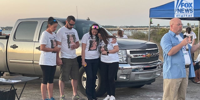 A crowd gathers at a vigil for Cassie Carli, a Florida mom who was found dead and buried in a shallow grave in a barn in Alabama on April 2, 2022.