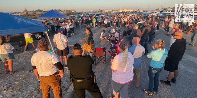 A crowd gathers at a vigil for Cassie Carli, a Florida mom who was found dead and buried in a shallow grave in a barn in Alabama on April 2, 2022.