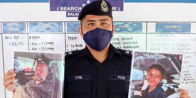 Mersing District Police Chief Cyril Edward Nuing shows pictures of British man Adrian Peter Chesters and French woman Alexia Alexandra Molina, who were found safe after drifting at sea for two and a half days off the coast of Malaysia. 