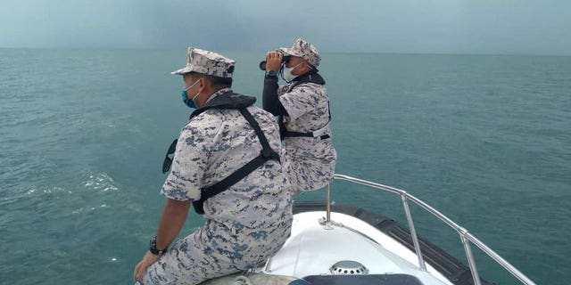 Malaysian Maritime Enforcement Agency officers search for missing divers off the Mersing coast, Johor, Malaysia, April 8, 2022. 