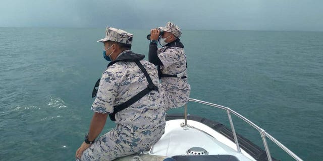 Malaysian Maritime Enforcement Agency officers search for missing divers off the Mersing coast, Johor, Malaysia, April 8, 2022.