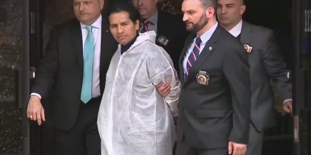 David Bonola being led out of the NYPD'S 112th precinct on April 21, 2022