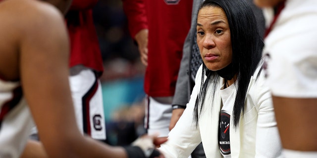 Head coach Dawn Staley of the South Carolina Gamecocks talks with her team during a timeout in the third quarter against the Louisville Cardinals during the 2022 NCAA Women's Final Four semifinal game at Target Center on April 01, 2022 in Minneapolis, Minnesota.