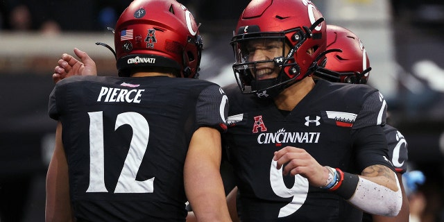 Alec Pierce # 12 and Desmond Knight # 9 of the Cincinnati Bearcats celebrate after scoring a touchdown in the second quarter against the SMU Mustangs at Nippert Stadium on November 20, 2021 in Cincinnati, Ohio.