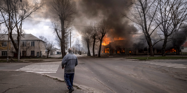 A man walks on a street in Severodonetsk, ウクライナ東部, following shelling there on Wednesday. 