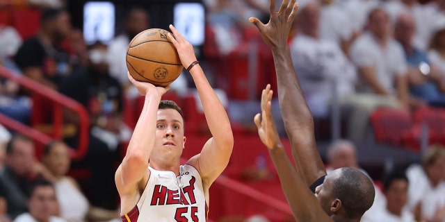 Duncan Robinson #55 of the Miami Heat shoots a three pointer over Gorgui Dieng #10 of the Atlanta Hawks during the second half in Game One of the Eastern Conference First Round at FTX Arena on April 17, 2022 in Miami, Florida.