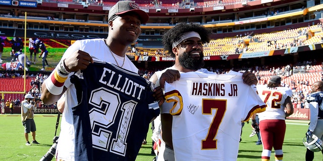 Dwayne Haskins #7 of the Washington Redskins and Ezekiel Elliott #21 of the Dallas Cowboys pose for a picture after swapping jerseys at the end of the game at FedExField on Sept. 15, 2019 in Landover, Maryland.