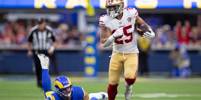Elijah Mitchell of the San Francisco 49ers runs after a catch against the Los Angeles Rams at SoFi Stadium on January 30, 2022 in Inglewood, California.