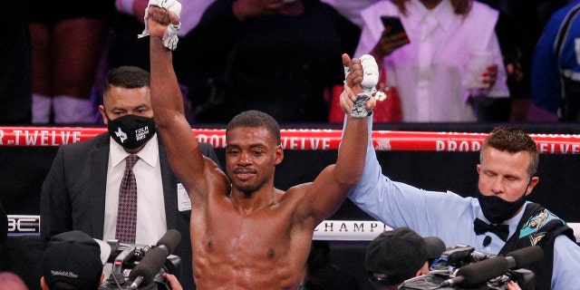 FILE - Errol Spence Jr. celebrates after defeating Danny Garcia by unanimous decision in a welterweight boxing bout in Arlington, Texas, Dec. 5, 2020.