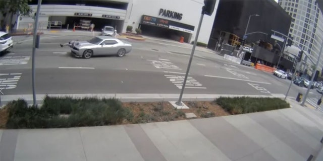 Video footage released by the LAPD shows criminal suspects hit a woman with a vehicle and robbing her after she left a jewelry store in the Jewelry District of Downtown Los Angeles. 