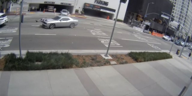 Video footage released by the LAPD shows criminal suspects hit a woman with a vehicle and robbing her after she left a jewelry store in the Jewelry District of Downtown Los Angeles.