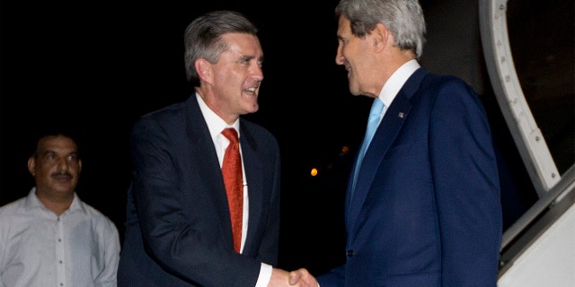 Secretary of State John Kerry is greeted by U.S. Ambassador to Pakistan Richard Olson upon his arrival in Islamabad, July 31, 2013.