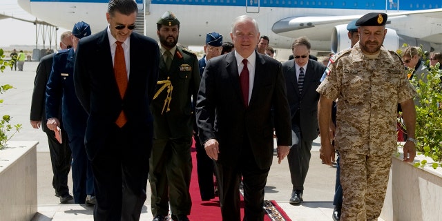 Defense Secretary Robert Gates walks with U.S. Ambassador to the UAE Richard Olson and others at the Al-Dhafra Air Base in Abu Dhabi, March 11, 2010.