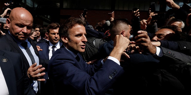 Newly re-elected French President Emmanuel Macron meets residents at the Saint-Christophe market square in Cergy, a Paris suburb, Wednesday, April 27, 2022. 