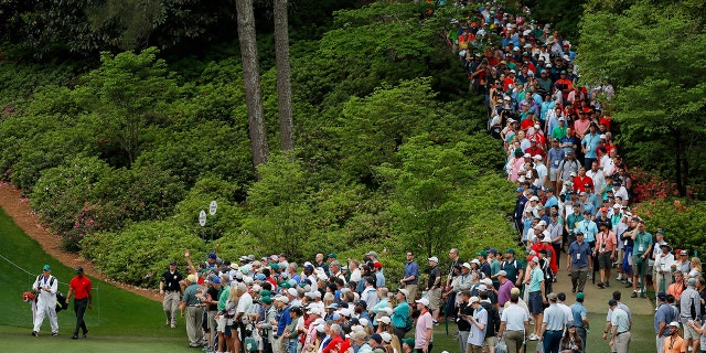 Tiger Woods walks onto the 6th hole as patrons gather during the Masters at Augusta National Golf Club on April 14, 2019.