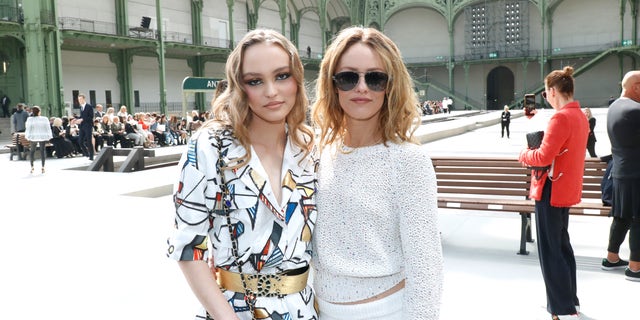 Lily-Rose Depp and Vanessa Paradis attend a fashion show.