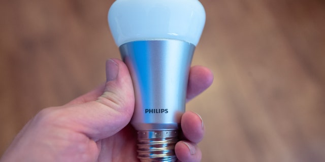 Close-up of hand of a man holding a Philips Hue web-connected smart lightbulb, August 29, 2019. (Photo by Smith Collection/Gado/Getty Images)