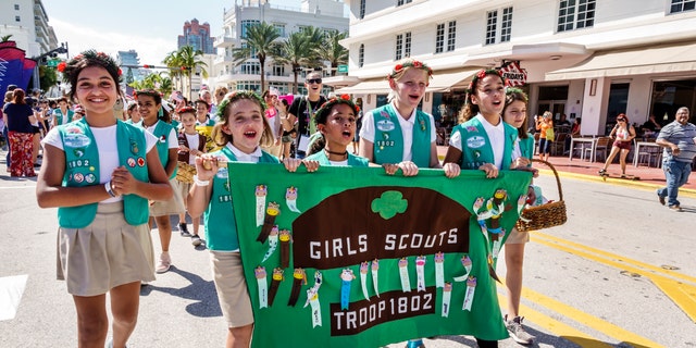 Miami Beach, Veterans Day Parade, Girl Scouts troop marching with banner.