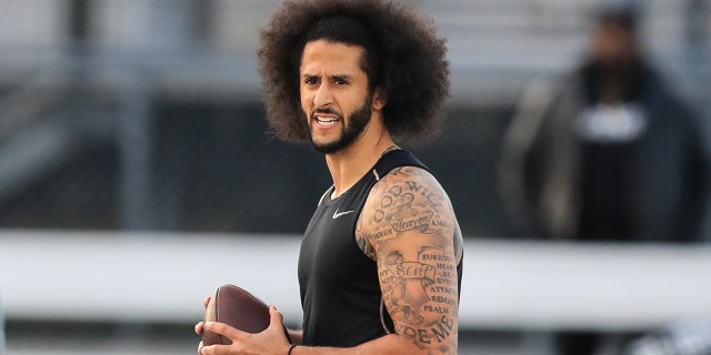 Colin Kaepernick looks to make a pass during a private NFL workout held at Charles R Drew high school on November 16, 2019, in Riverdale, Georgia. Due to disagreements between Kaepernick and the NFL the location of the workout was abruptly changed.  