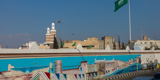 Saudi Arabian flag in front of a fresco, Asir province, Abha, Saudi Arabia on January 3, 2020 in Abha, Saudi Arabia. (Photo by Eric Lafforgue/Art in All of Us/Corbis via Getty Images)