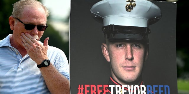 Joey Reed, the father of former U.S. Marine Trevor Reed, stands next to a placard of his son outside the U.S. Capitol in Washington, DC, on July 29, 2021, during a press conference. 