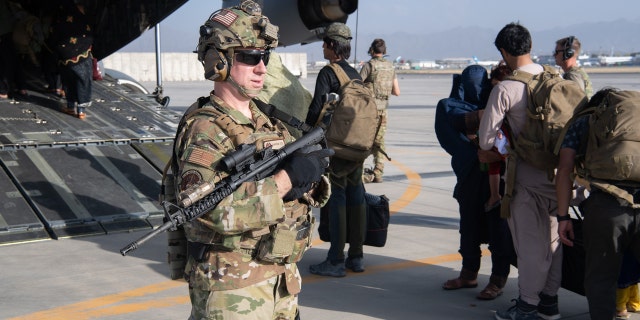 U.S. Air Force loadmasters and pilots assigned to the 816th Expeditionary Airlift Squadron load passengers aboard a U.S. Air Force C-17 Globemaster III in support of the Afghanistan evacuation at Hamid Karzai International Airport in Kabul, Afghanistan, on Aug. 24, 2021.