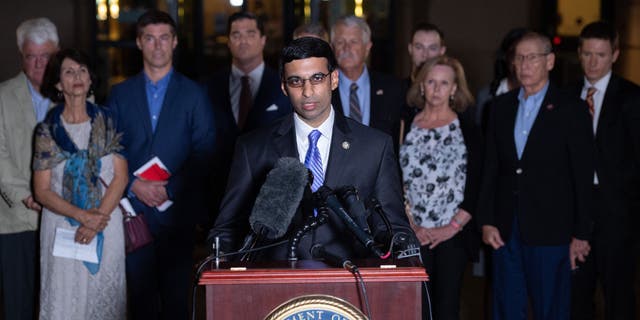 Acting US Attorney Raj Parekh (C), of the Eastern District of Virginia, speaks following the guilty pleas by Alexanda Kotey, a member of the notorious Islamic State kidnapping cell dubbed the "Beatles," to charges of conspiring to murder four American hostages, alongside the victims' families, outside the US District Court in Alexandria, Virginia, Sept. 2, 2021. 