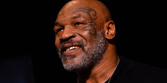 Mike Tyson shows off his face tattoo