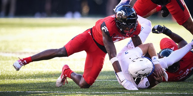 Cincinnati's Ahmad "Sauce" Gardner tackles Tulsa QB Davis Brin on Nov. 6, 2021, at Nippert Stadium in Cincinnati, Ohio.