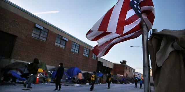 An American flag flies on Atkinson Street in Boston on Jan. 12, 2022.