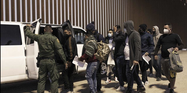 Feb. 17, 2022: Migrants seeking asylum board a U.S. Customs and Border Protection vehicle to be transferred to temporary shelter in Yuma, Arizona, U.S. Photographer: Nicolo Filippo Rosso/Bloomberg via Getty Images