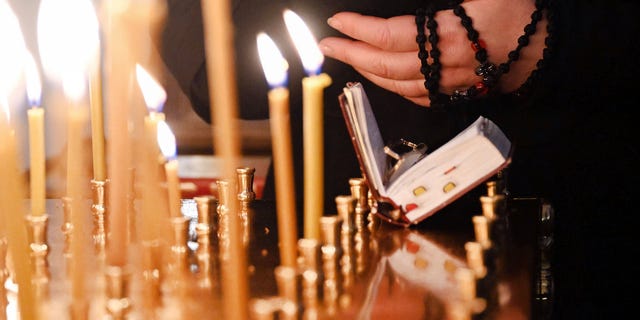 Candles burn during a Russian Orthodox service at Christ the Redeemer Parish on February 27, 2022.