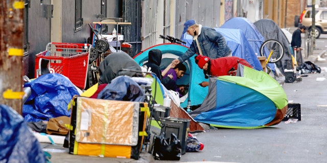 Homeless people consume illegal drugs in an encampment along Willow St. in the Tenderloin district of downtown on Thursday, Feb. 24, 2022 in San Francisco, CA. London Breed, mayor of San Francisco, is the 45th mayor of the City and County of San Francisco. She was supervisor for District 5 and was president of the Board of Supervisors from 2015 to 2018.