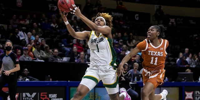 Baylor forward NaLyssa Smith ( 1 ) goes up for a layup past Texas guard Joanne Allen-Taylor ( 11 ) during the Big12 Women's Championship final between the Baylor Bears and the Texas Longhorns on Sunday March 13, 2022, at Municipal Auditorium in Kansas City, MO. Smith has a chance to go No. 1 overall in the draft.