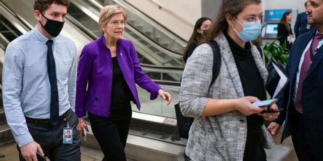 Senator Elizabeth Warren, a Democrat from Massachusetts, second left, walks through the basement of the U.S. Capitol in Washington, D.C., U.S., on Wednesday, March 30, 2022. 