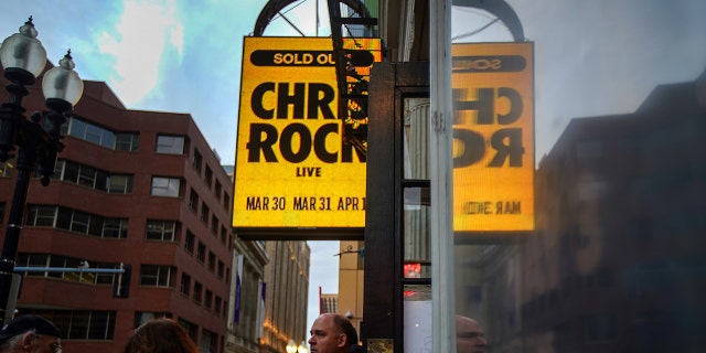 Chris Rock Says He’ll Talk about Slap Controversy When He’s “Paid” 1 Boston, MA - March 30: Ticket holders enter the Wilbur Theater to see actor/comedian Chris Rock at the Wilbur Theater for the first of his two performances on March 30, 2022. (Photo by Barry Chin/The Boston Globe via Getty Images)
