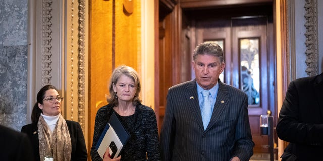 Sen. Lisa Murkowski (R-AK) speaks with Sen. Joe Manchin (D-WV) outside the Senate Chamber at the United States Capitol on April 7, 2022 in Washington, DC.