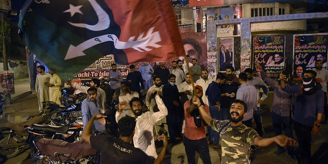 Opposition parties supporters celebrate the dismissed Pakistan's prime minister Imran Khan in Karachi on April 10, 2022.