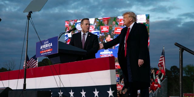 Ted Budd, who is running for U.S. Senate, joins the stage with former U.S. President Donald Trump during a rally at The Farm at 95 on April 9, 2022, in Selma, North Carolina.