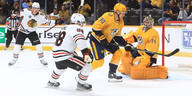Chicago Blackhawks center Dylan Strome, left, celebrates a goal by teammate Patrick Kane against the Predators on April 16, 2022, at Bridgestone Arena in Nashville, Tennessee.
