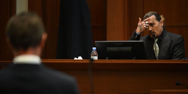 Johnny Depp testifies during his defamation trial in the Fairfax County Circuit Courthouse in Fairfax, Va., April 19, 2022.
