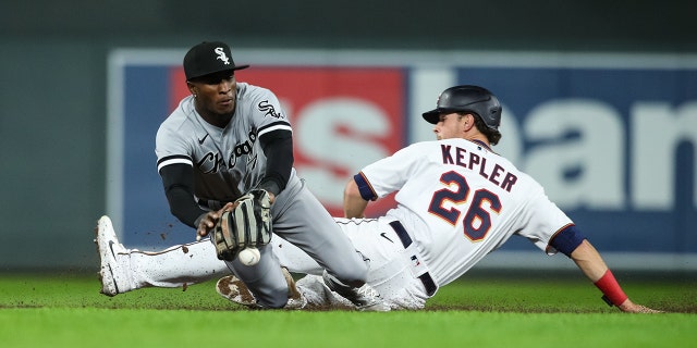 Tim Anderson # 7 of the Chicago White Sox hits the ball as Max Kepler # 26 of the Minnesota Twins slides safely into second base in the game's seventh inning at Target Field on April 22, 2022 in Minneapolis, Minnesota. The Twins defeated the White Sox 2-1.