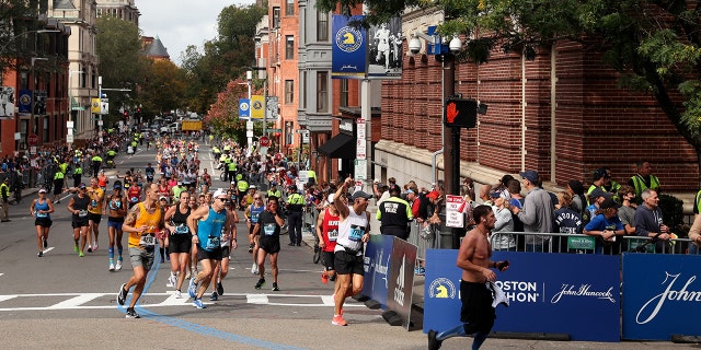 BOSTON, MASSACHUSETTS - OCTOBER 11: Runners turn onto Boylston street during the 125th Boston Marathon on October 11, 2021, in Boston, Massachusetts.
