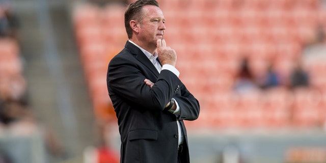 Houston Dash head coach James Clarkson watches during a game between North Carolina Courage and Houston Dash at BBVA Stadium on October 10, 2021, in Houston, Texas.