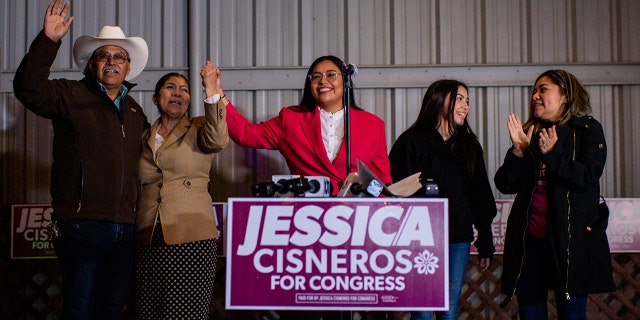 Democratic U.S. congressional candidate Jessica Cisneros concludes a speech alongside her family during a watch party on March 01, 2022 in Laredo, Texas.